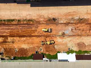 Aerial view yellow grader building a highway, Grader that is making roads and adjusting the area at the construction site. Bulldozer working at road construction. Compactor roller © Яe Life Яe World