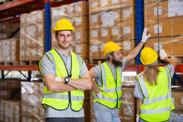 portrait of man wearing safety uniform looking at camera standing in warehouse factory. Male...