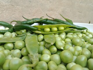 Grains or seed of Pisum sativum with Lycopersicon esculentum or Capsicum annuum L Green chilli or pea grains or seeds with Green chilli or garden pea seeds or grains with Green chilli