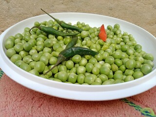 Grains or seed of Pisum sativum with Lycopersicon esculentum or Capsicum annuum L Green chilli or pea grains or seeds with Green chilli or garden pea seeds or grains with Green chilli