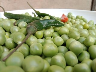 Grains or seed of Pisum sativum with Lycopersicon esculentum or Capsicum annuum L Green chilli or pea grains or seeds with Green chilli or garden pea seeds or grains with Green chilli