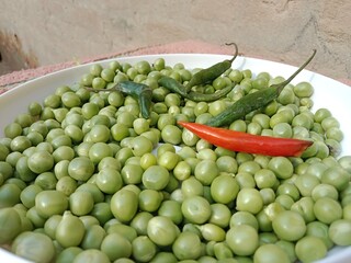 Grains or seed of Pisum sativum with Lycopersicon esculentum or Capsicum annuum L Green chilli or pea grains or seeds with Green chilli or garden pea seeds or grains with Green chilli