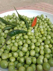 Grains or seed of Pisum sativum with Lycopersicon esculentum or Capsicum annuum L Green chilli or pea grains or seeds with Green chilli or garden pea seeds or grains with Green chilli