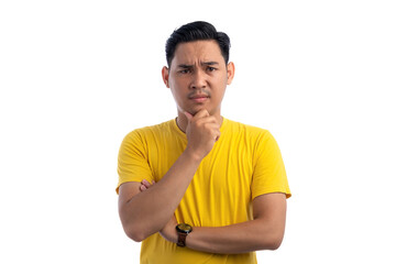 Handsome Asian man holding his chin, looking at the camera with suspicion expression isolated on white background