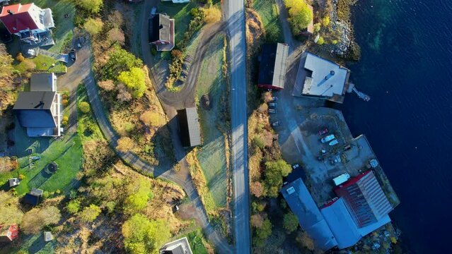 Aerial Birds Eye view of a Norwegian settlement inside a Fjord during autumn Season