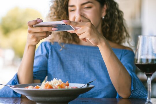 Young Woman Taking Photo Food While Having Lunch Restaurant