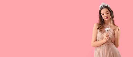 Beautiful young woman in prom dress and with flower on pink background © Pixel-Shot