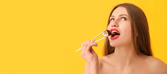 Beautiful young woman with tasty sushi roll on color background