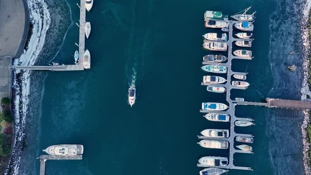 Boat Sailing Through Marina On Thea Foss Waterway In Daytime. Tacoma, Washington, USA. aerial topdown shot