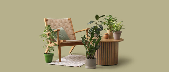 Wooden coffee table with houseplants and armchair on green background