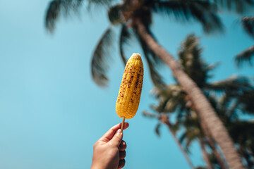 Grilled corn on skewers by the sea