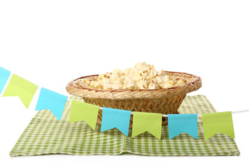 Straw hat with popcorn, napkin and paper flags on white background. Festa Junina (June Festival) celebration