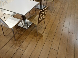 Several chairs and a table on the parquet floor