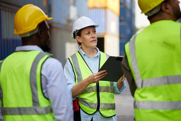 workers and coworkers looking at containers warehouse storage