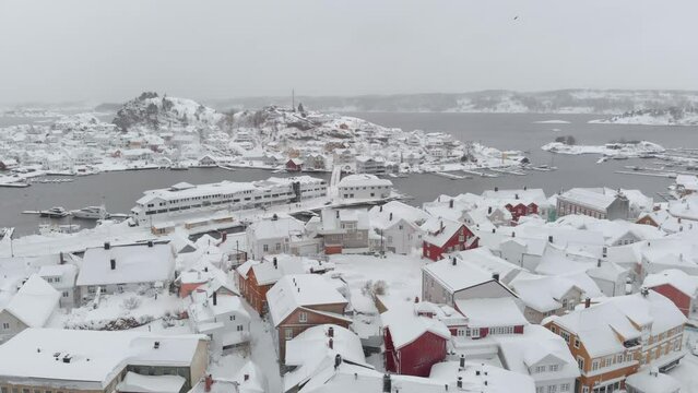 Kragero, Telemark County, Norway - A Picturesque Town Blanketed in Snow on a Winter Day - Drone Flying Forward