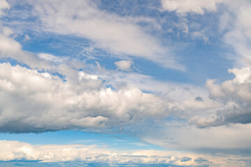 Dramatic white stormy clouds over a blue sky background