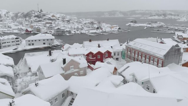 Kragero, Telemark County, Norway - A Charming Town Draped in Snow on a Wintry Day - Aerial Pullback Shot