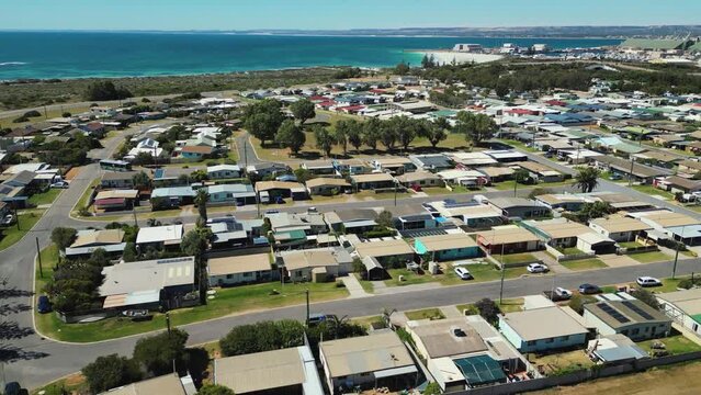 Real state - Aerial view of a neighborhood in the small town of Geraldton with Indian Ocean in the background during a sunny day - Western Australia