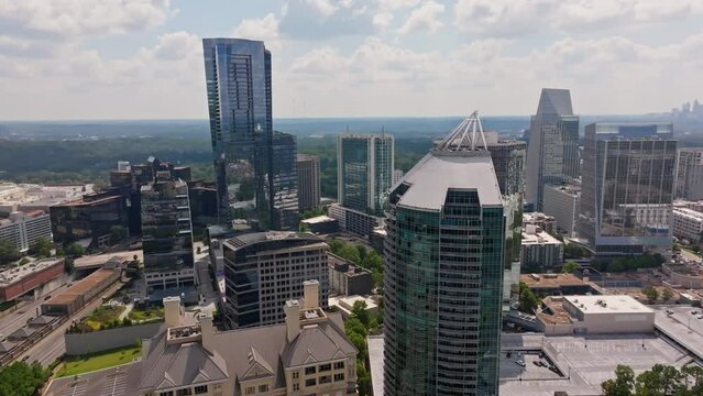 Luxury Apartments in modern skyscraper tower. Sunny day in Buckhead, Atlanta, USA. Aerial orbit shot.