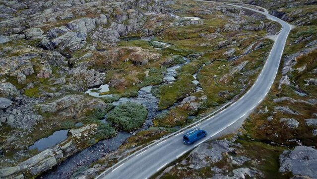 Aerial footage of blue van on small road in Norway. Amazing landscape.