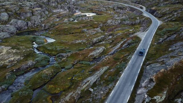 Aerial footage of blue van on small road in Norway. Amazing landscape.