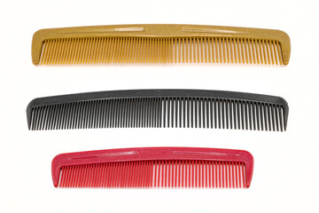 three combs of different sizes isolated on a white background