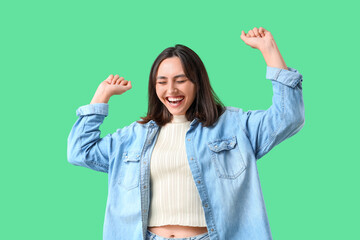 Happy young woman on green background