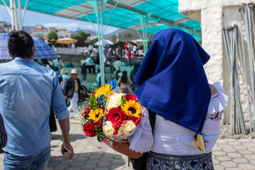 Otavalo woman carrying flowers in the ritual of the day of the dead - obrazy, fototapety, plakaty
