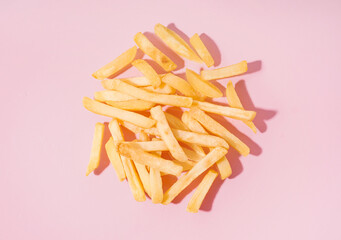 Tasty french fries on pink background