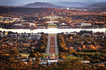 A panorama view of the Parliament House and the city of Canberra from Mount Ainslie Lookout in the dusk in autumn - obrazy, fototapety, plakaty