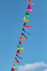 colorful flags against the blue sky