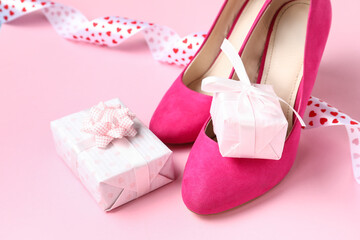 Beautiful gift boxes with stylish high heels on pink background. Valentines Day celebration