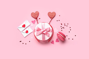 Beautiful gift box with love letters and tasty macaroon on pink background. Valentines Day...