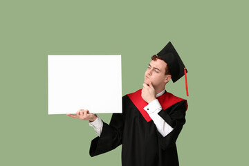 Thoughtful male graduating student with blank poster on green background
