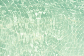 Blue water surface texture with ripples, splashes, and bubbles. Abstract summer banner background Water waves in sunlight with copy space cosmetic moisturizer micellar toner emulsion. Blue water wave.