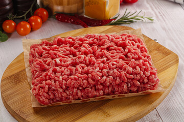 Raw minced beef meat over board