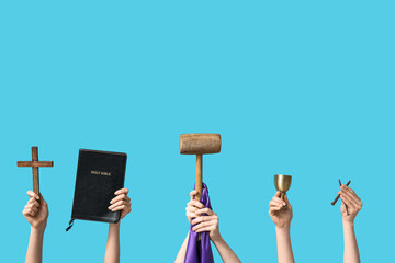 Female hands with Holy Bible, cross, mallet and nails on color background. Good Friday concept