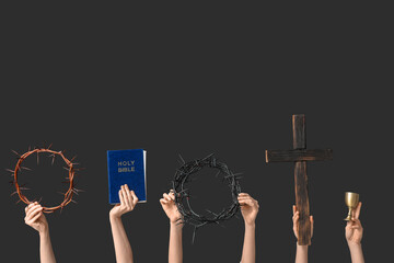 Female hands with crowns of thorns, Holy Bible and wooden cross on dark background. Good Friday...
