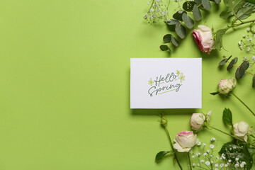 Greeting card with text HELLO SPRING, beautiful roses, gypsophila flowers and eucalyptus on green...