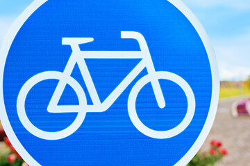 A traffic sign displaying a white bicycle on a blue background is a symbol for bicycle lanes. The azure color pops with the font style, reminding motor vehicles to watch out for cyclists
