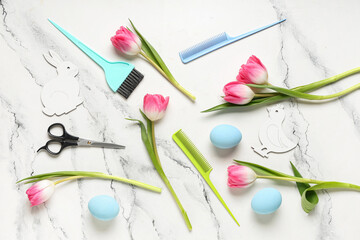 Composition with hairdresser's tools, tulip flowers and Easter eggs on light background