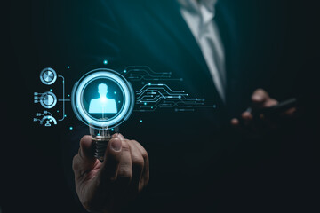 Businessman working on laptop and hold light bulb virtual screen human resources digital network hologram. Digital HR Network. HR Human resources find employee or worker concept.