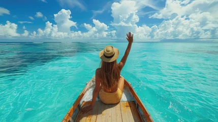  A happy woman is waving hand, relaxing on boat at clear blue sea beach on her summer holiday.  © ANEK
