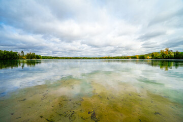 Obraz premium Baggersee Weingarten near Karlsruhe with the surrounding nature. Autumn landscape by the lake. 