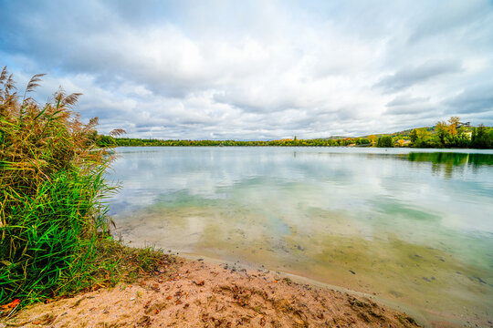 Baggersee Weingarten near Karlsruhe with the surrounding nature. Autumn landscape by the lake.
