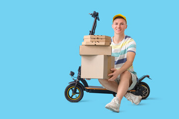 Male courier with pizza boxes, parcels and kick scooter on blue background - obrazy, fototapety, plakaty