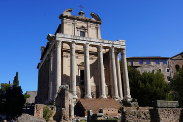 Fototapeta na wymiar Ruins of the temple of the Roman emperor Antoninus Pius and his wife Annia Faustina, and the Christian church of San Lorenzo in Miranda, in the forum of Rome, in Italy
