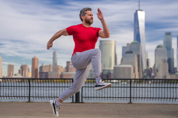 Fototapeta na wymiar Runner man. Healthy sport. Man running in New York City. Fitness man runner is jogging near Manhattan. Guy running on American street. Man running in New York in sport clothes. Sport wear for runners.