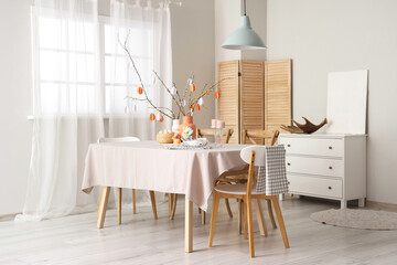 Stylish interior of dining room with Easter table setting