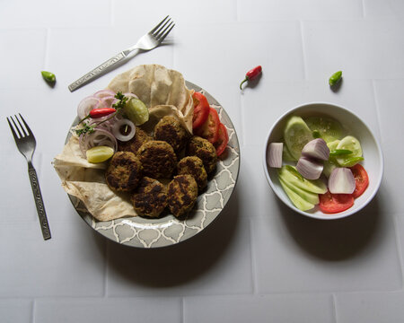 Shami kebab or meat kebab served with paratha or Indian bread in a bowl.